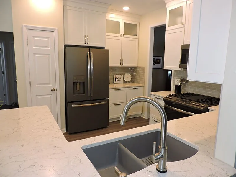 Bright white kitchen in Caledonia with cabinetry taken up to the ceiling
