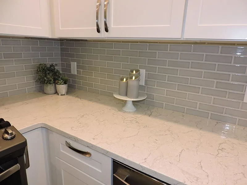 Grey subway tile backsplash and quartz counter in the Caledonia kitchen